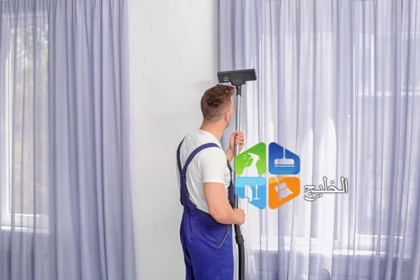 a man in overalls holding a vacuum cleaner